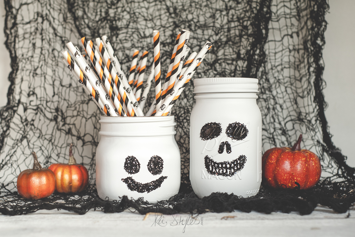 Ghost and skull painted mason jars for Halloween.