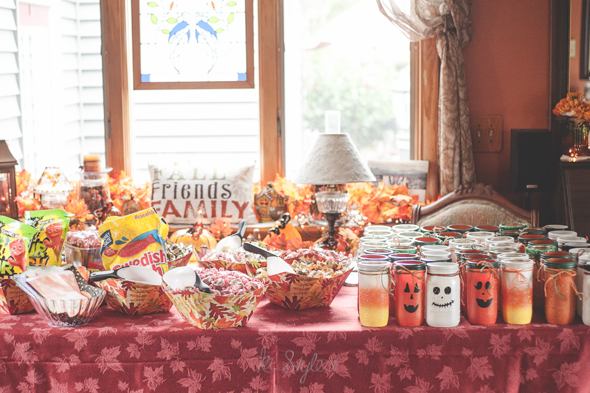 Halloween candy table. Candy corn, pumpkin and ghost mason jars.